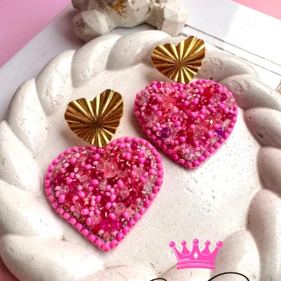 Aretes livianos en forma de corazon recamado en mostacillas, canutillo y muranos tonalidades en rosa. Poste en baño de oro