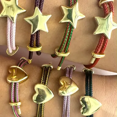 Pulseras de cordón trenzado con dije de estrella dorada en varios colores